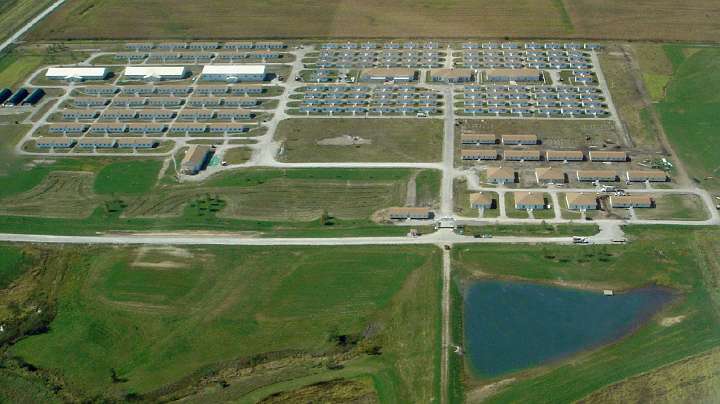 6 Iowa Aerial Sept 30 2009.jpg - An aerial photo of the Maharishi Vedic Pandit campus in Maharishi Vedic City, Iowa. The  220,000 square feet  include seven Mandap  buildings (buildings specifically for the performance of Maharishi's Vedic Technologies), two dining halls, a recreation hall (cricket is a popular sport)  housing for over 1,000 Pandits  according to Maharishi Sthapathya Veda. Ten of the longer buildings on the lower right, residential and kitchen structures, were brought over from the Mother Divine campus to accommodate quick expansion.